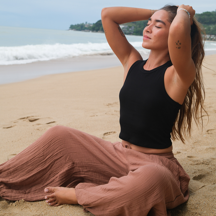 Black Cropped Rio Racerback Ribbed Tank, worn on the beach with boombox
