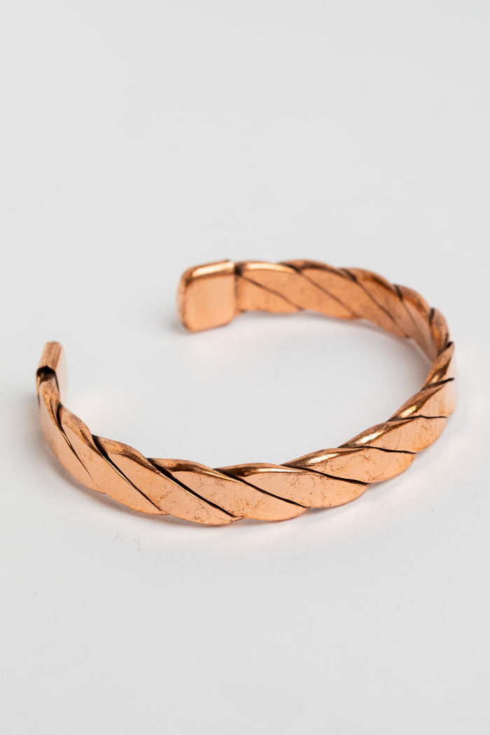 copper cuff bracelet in twist on white background