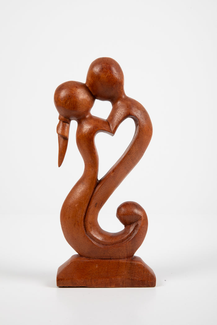Kissing carved wooden sculpture in love