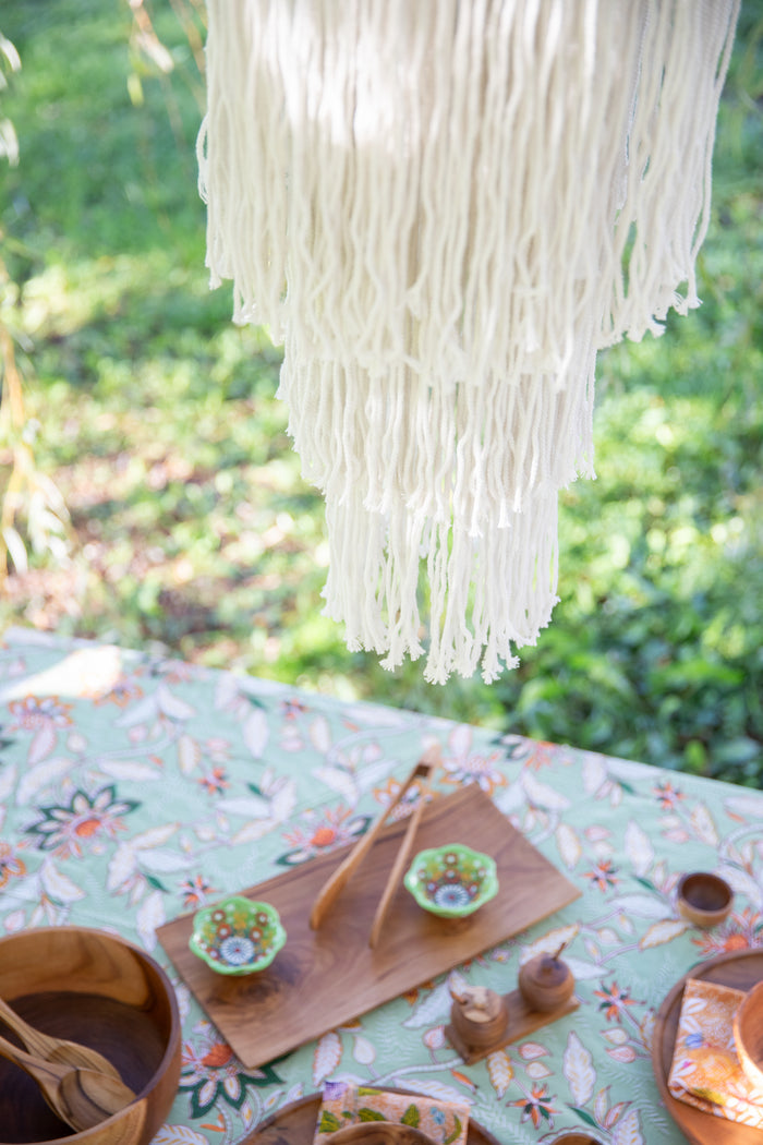macrame chandelier hanging over bohemian table
