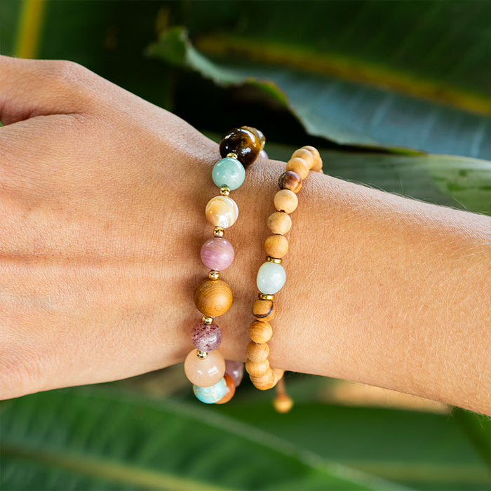 Renew Statement Healing Bracelet, on wrist with tropical leaf