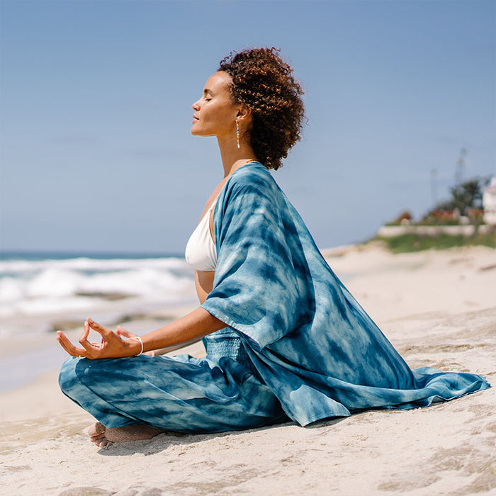 Turquoise Tide Kimono, seated on the beach