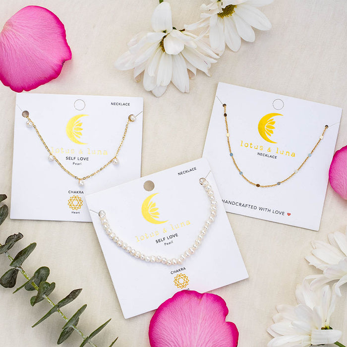 3mm Self Love Dewdrop Necklace, on cards with flowers
