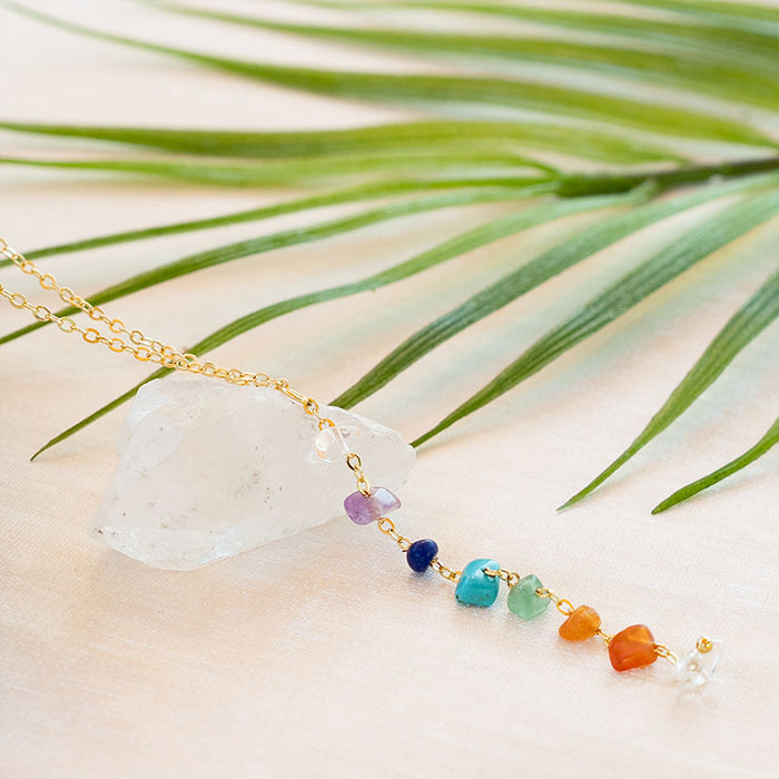 7 Chakras Raw Stone Healing Necklace, flat lay with crystal