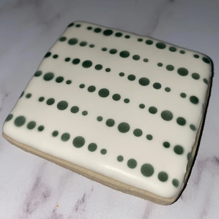 Dynamic Dots Pattern Cookie Stencil airbrushed in black on a white square cookie.