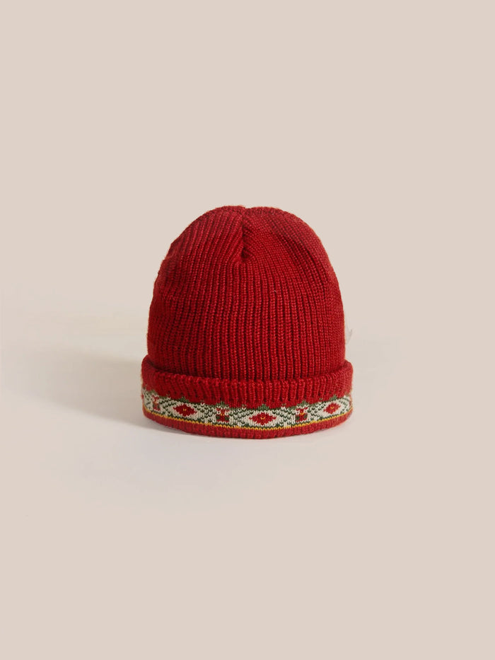 The Profound Ajrak Beanie is a chunky red knit hat featuring a decorative patterned band around the brim, crafted from soft cotton for added comfort.