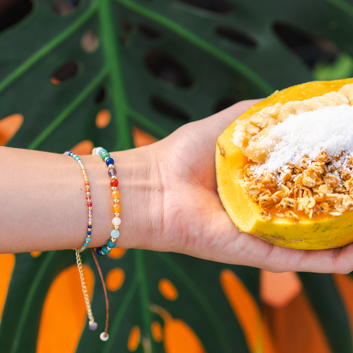 Aloha State of Mind 4mm Healing Bracelet, on wrist with papaya