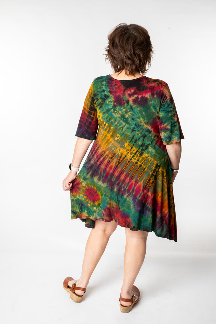 Betty is wearing a tie dye dress in green