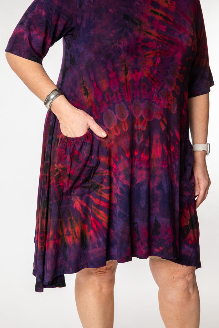 Betty is wearing a tie dye dress in eggplant