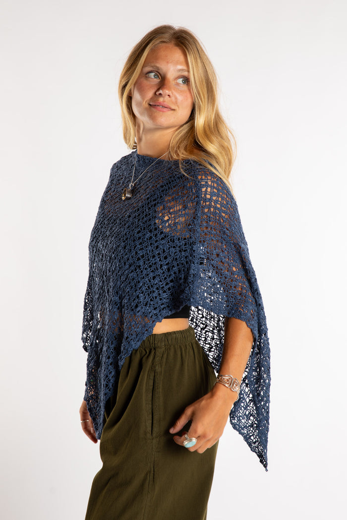 Susan is wear the Asymmetrical Loose Weave Poncho in Navy