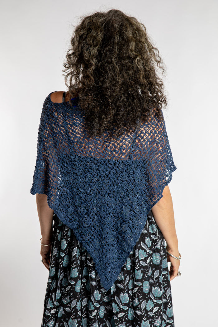 Susan is wear the Asymmetrical Loose Weave Poncho in Navy