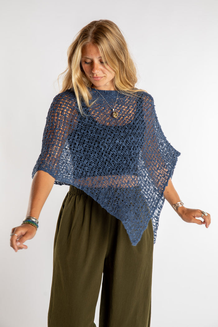 Sophie is wear the Asymmetrical Loose Weave Poncho in Navy