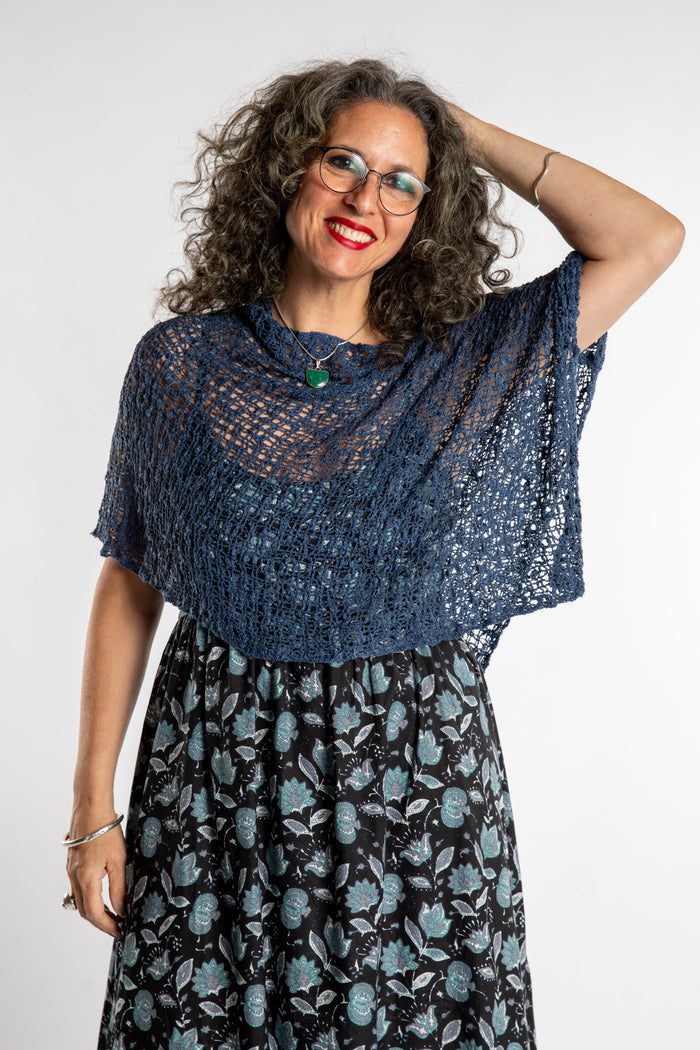 Susan is wear the Asymmetrical Loose Weave Poncho in Navy