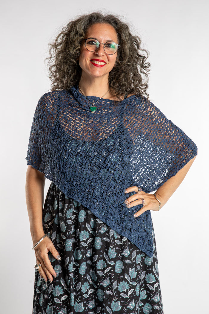Susan is wear the Asymmetrical Loose Weave Poncho in Navy