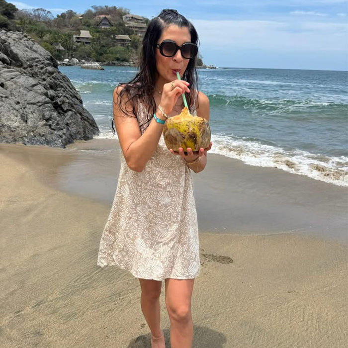 Avalon Barefoot Beach Dress, on the beach with a coconut