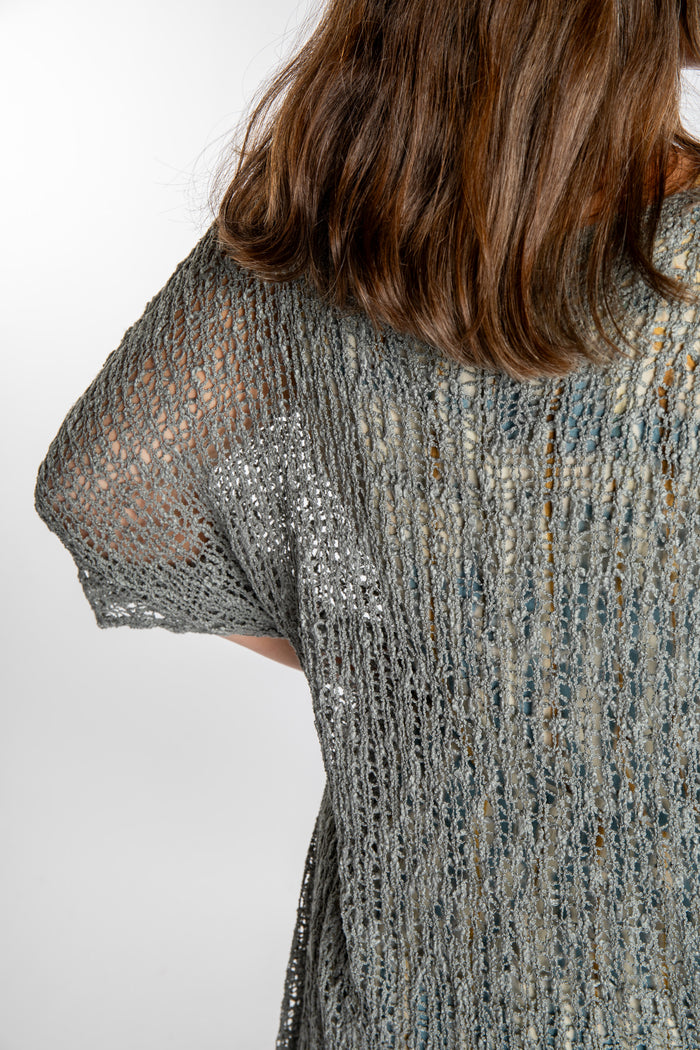 Holly is wearing the Gray loose knit cover up