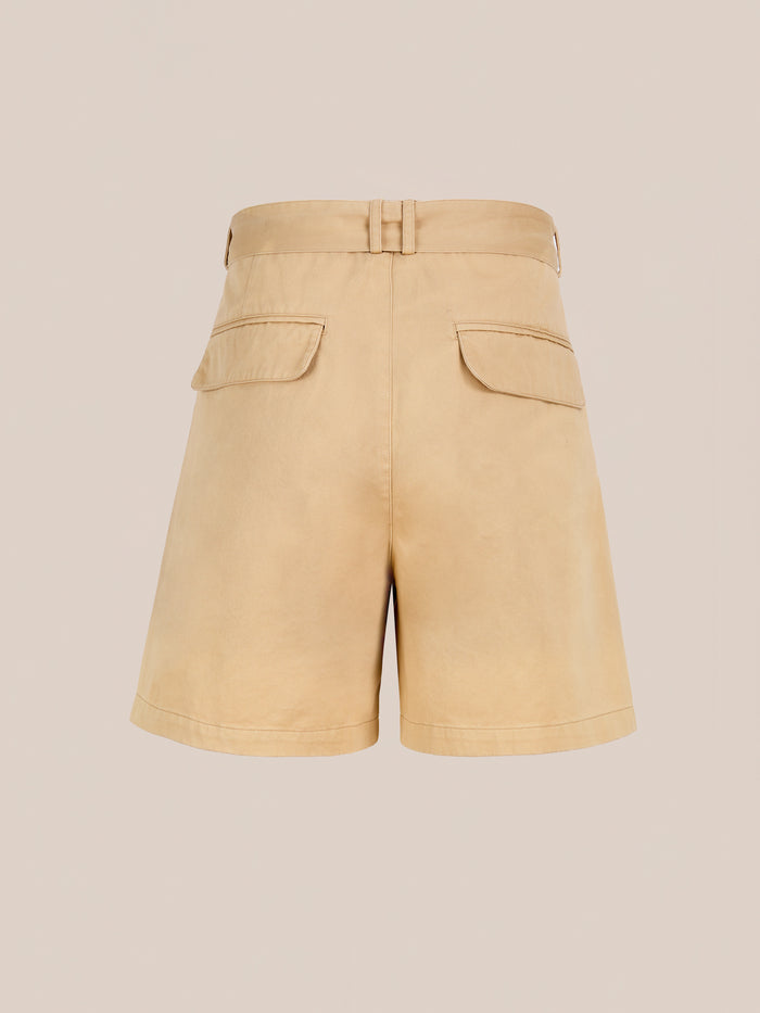 Found Belted Twill Pleated Shorts in beige, featuring a high waist, belt loops, and two back flap pockets, are shown against a plain light background.
