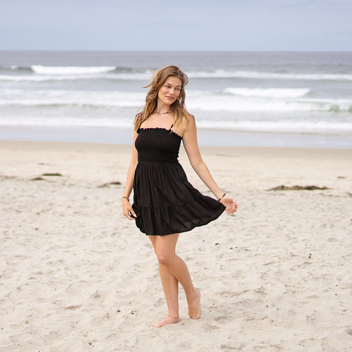 Black Daiquiri Dress with Adjustable Straps, worn on the beach