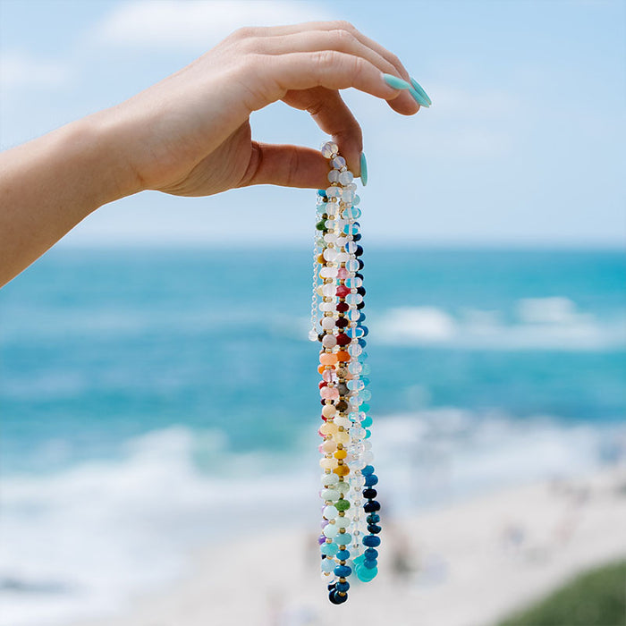 Blue Crush Statement Healing Necklace, styles held up at the beach