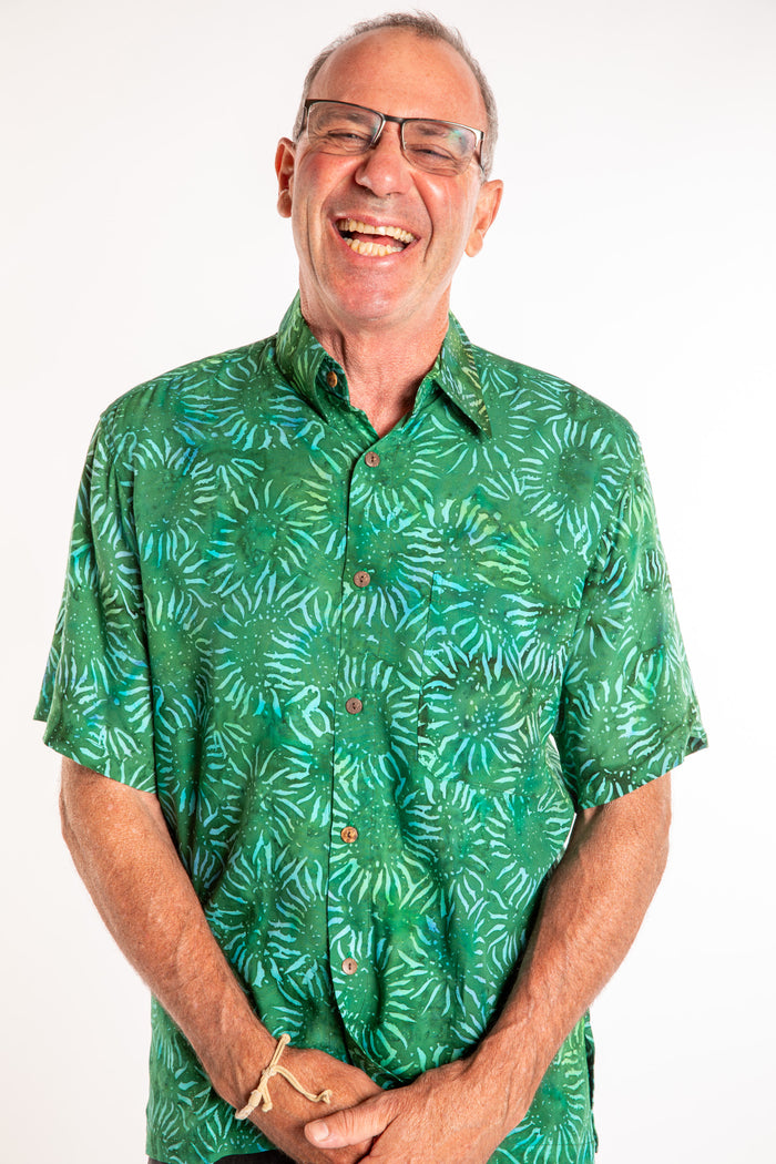 Ross wearing a M green floral batik shirt in Forest Green