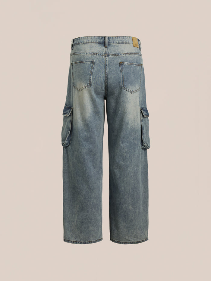 Back view of FOUND's Cargo Jeans, light blue with a relaxed fit, featuring side pockets and a faded wash that highlights workwear durability on a neutral background.