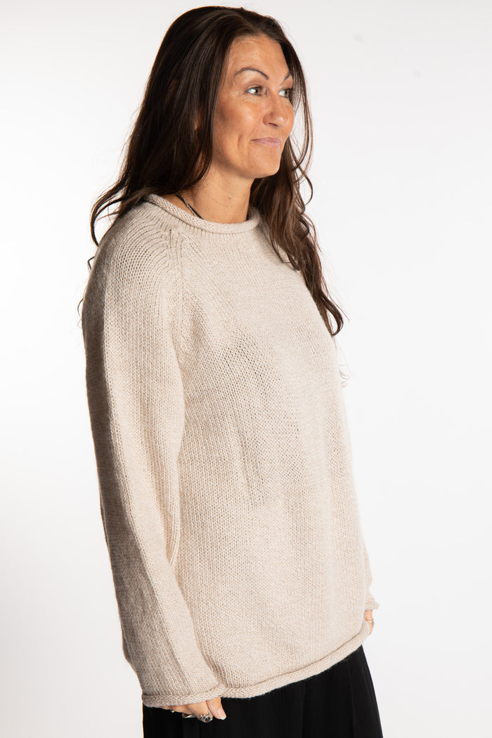 Jen wearing a size large oatmeal fisherman style sweater