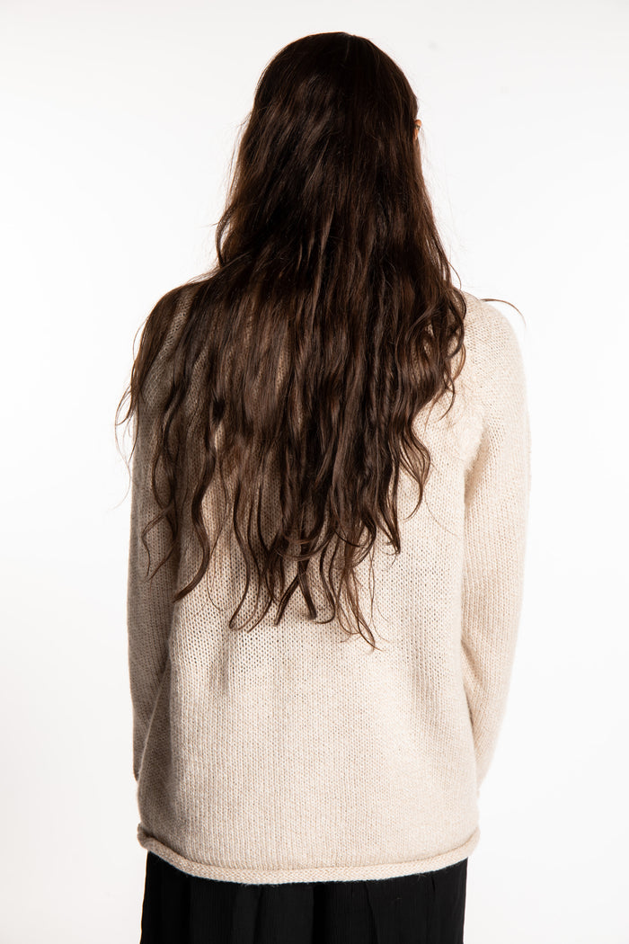 Jen wearing a size large oatmeal fisherman style sweater