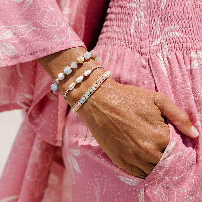 Coconut Crush Healing Bracelet, stacked over pink dress