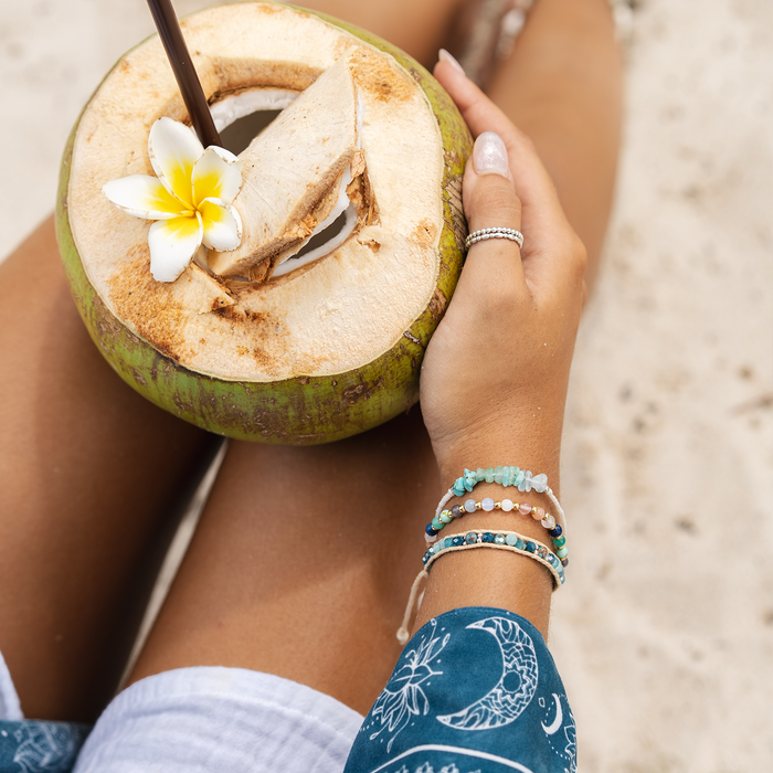 Compassion Healing 4mm Bracelet, worn with a coconut overhead