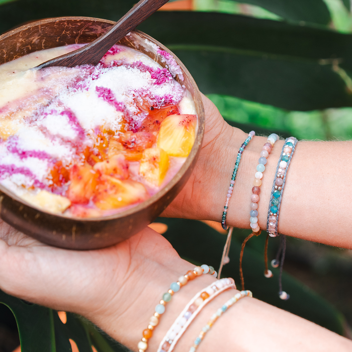 Compassion Healing 4mm Bracelet, worn holding a smoothie bowl