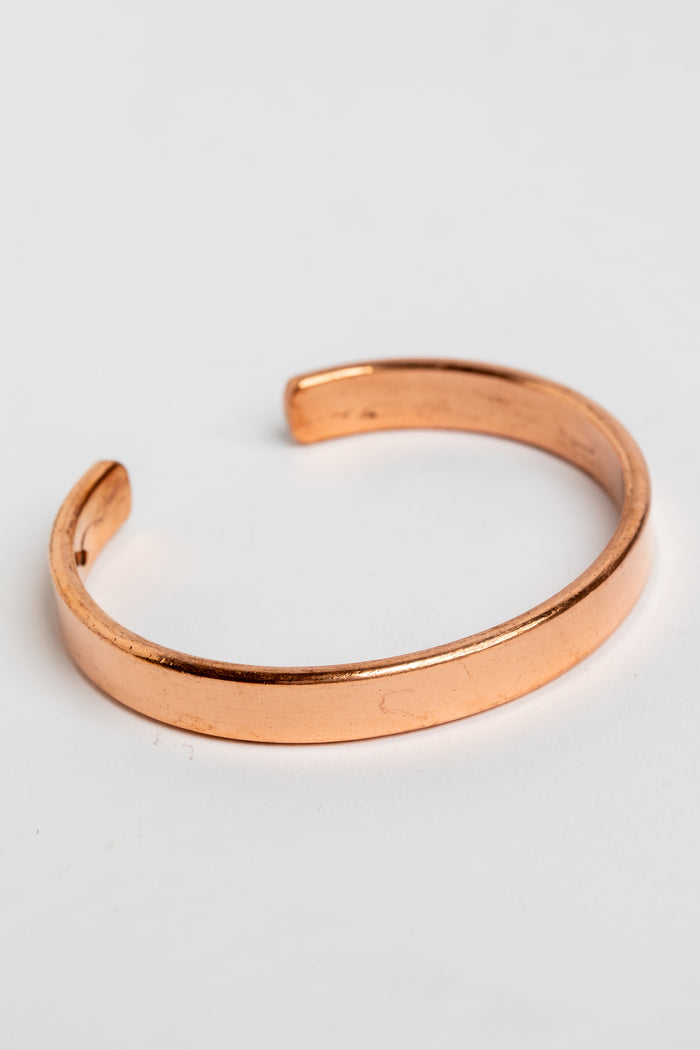 copper cuff bracelet in simple on white background