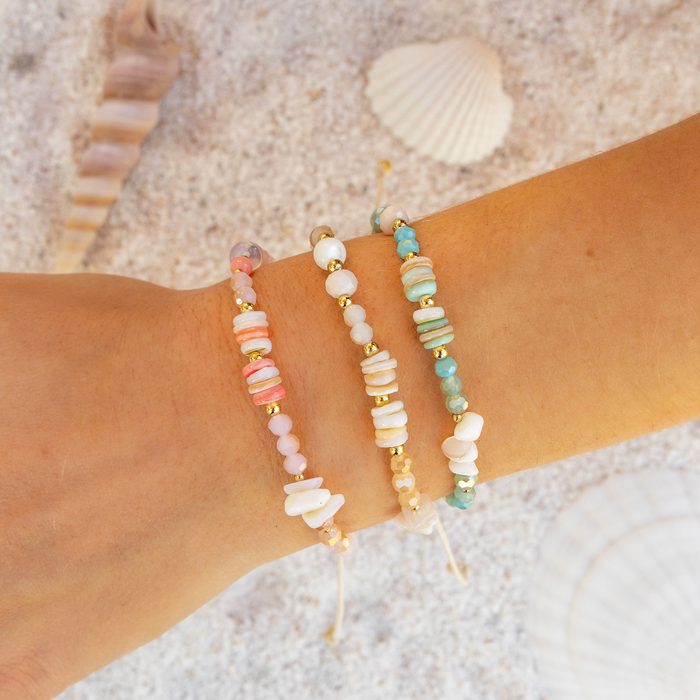 Coral Bloom Crystal Tide Bracelet, stacked on wrist in the sand