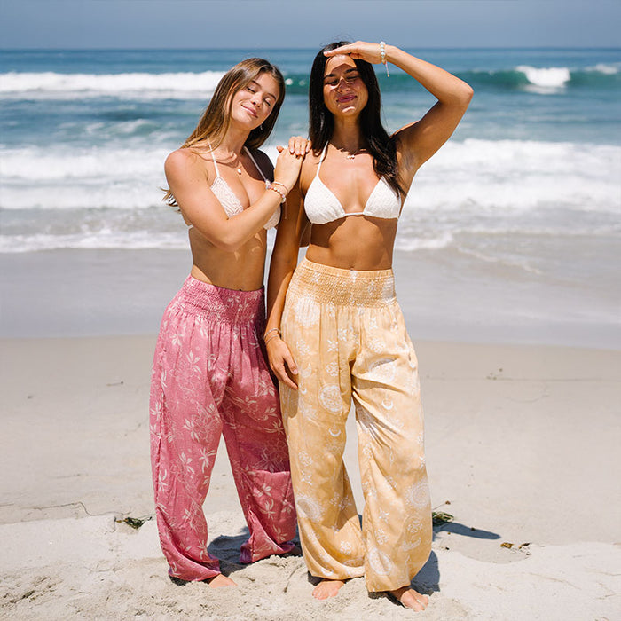 Coral Bloom Harem Pants, on the beach with two models