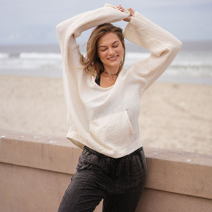 Cream Baja Pullover, worn against sea wall