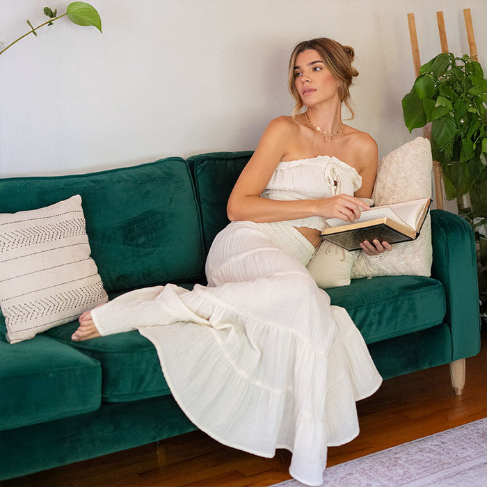 Cream Sundrift Maxi Skirt, reclining on couch