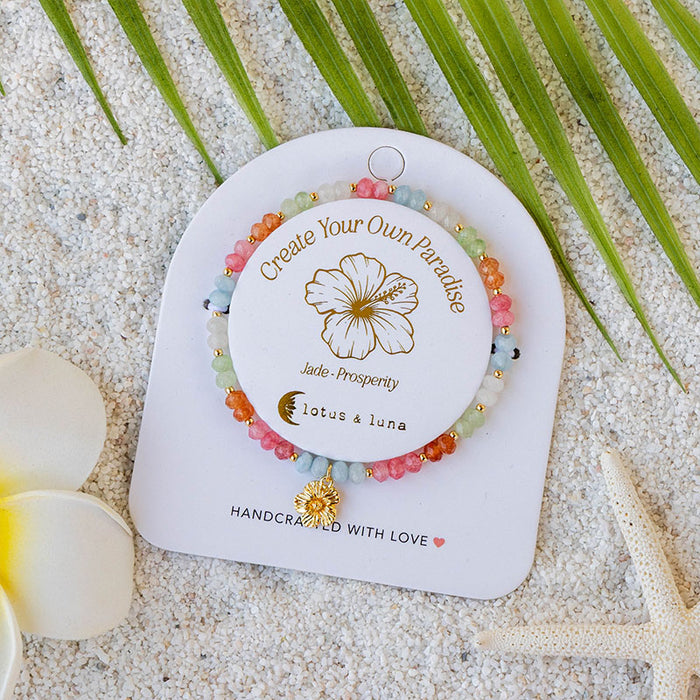 "Create Your Own Paradise" Mantra Bracelet, on card on sand
