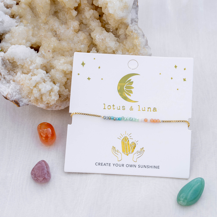 "Create Your Own Sunshine" Goddess Bracelet, flat lay on card