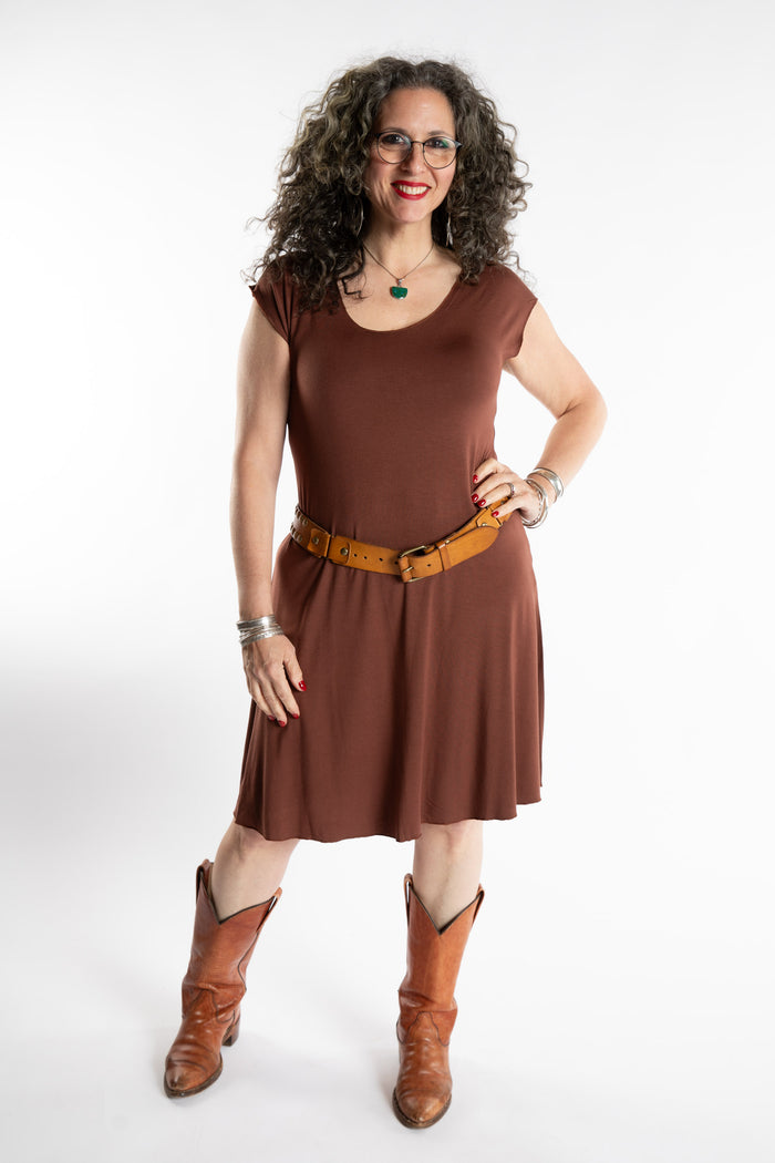 Susan is wearing the Dancing Daze Dress in Brown in Medium