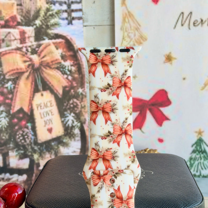 Close-up of a single Deck The Halls With Bows & Holly Apple Watch band strap, vintage Christmas bow print on ivory