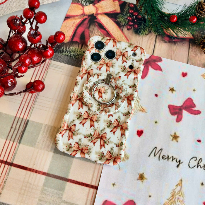 Deck The Halls With Bows & Holly iPhone case with the matching grip ring snapped on, on cream plaid with red berries and Merry Christmas paper