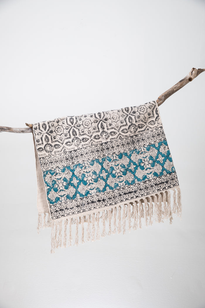 Block print woven rug in natural and teal