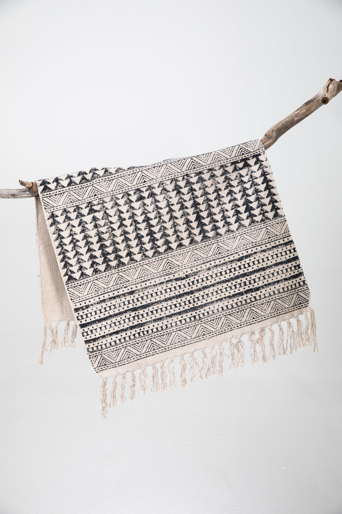 Block print woven rug in natural and black
