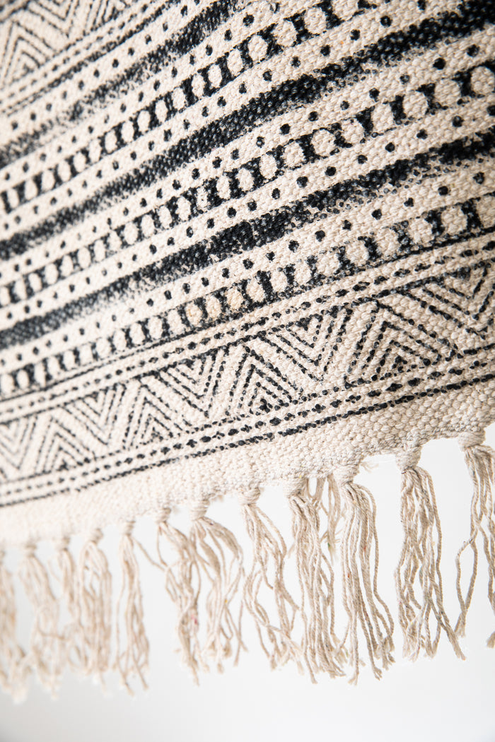 Block print woven rug in natural and black
