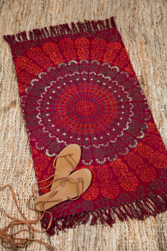 Block print woven rug in red mandala