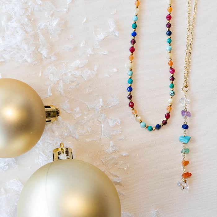 Divine Healer + 7 Chakra Raw Stone Necklace Stack, flat lay with ornaments