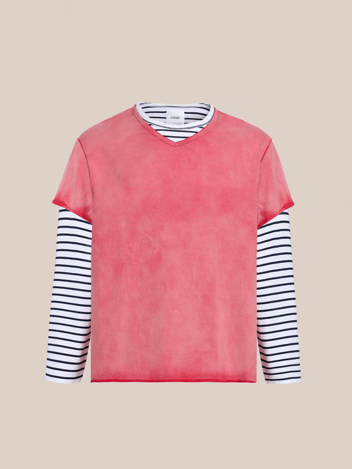 FOUND’s Double Layer LS Tee in unisex relaxed fit features black and white stripes under a solid pink short-sleeve top, shown against a plain beige background.