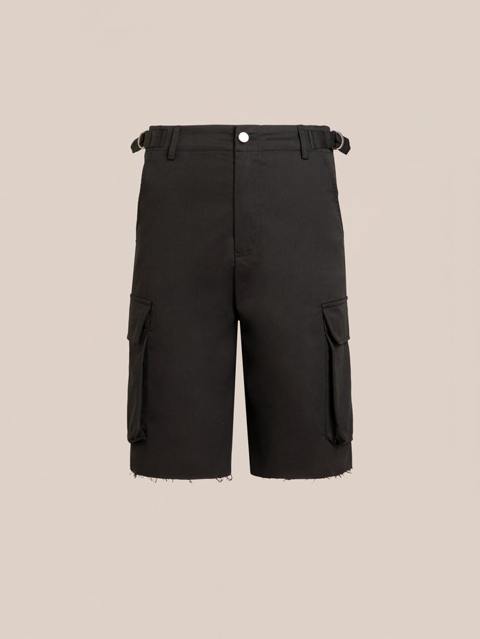 Found Elbas Cargo Shorts in black feature dual cargo pockets, belt loops, front button closure, side pockets, adjustable waist tabs, and raw-edged hems on a plain beige background.