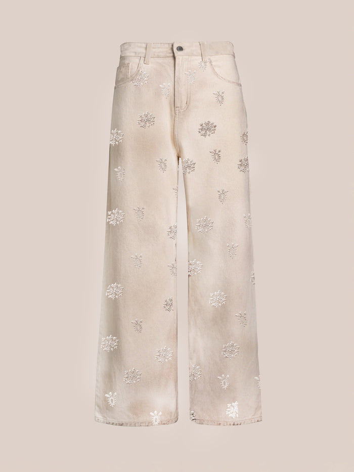 FOUND’s Embroidered Motif Jeans feature a relaxed wide-leg, high-waist design in cream with subtle floral embroidery throughout.