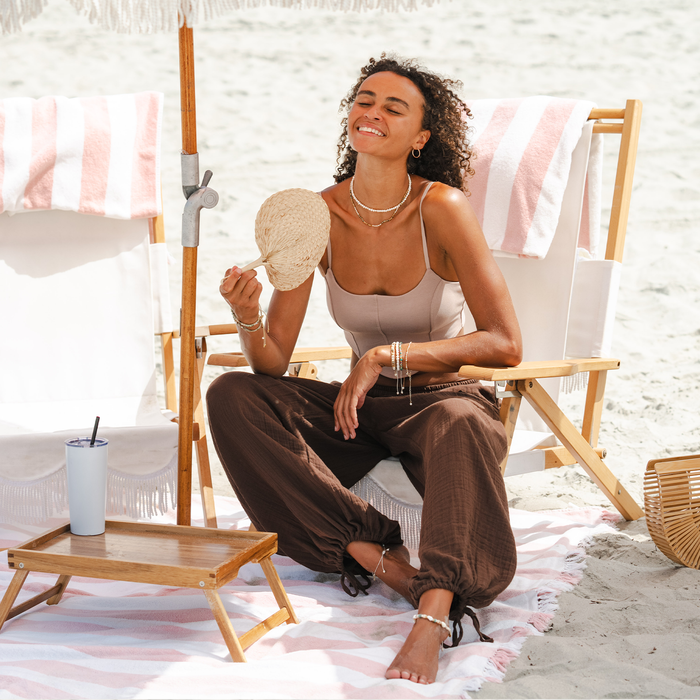 Espresso Adventure Cargo Pants, seated on the beach