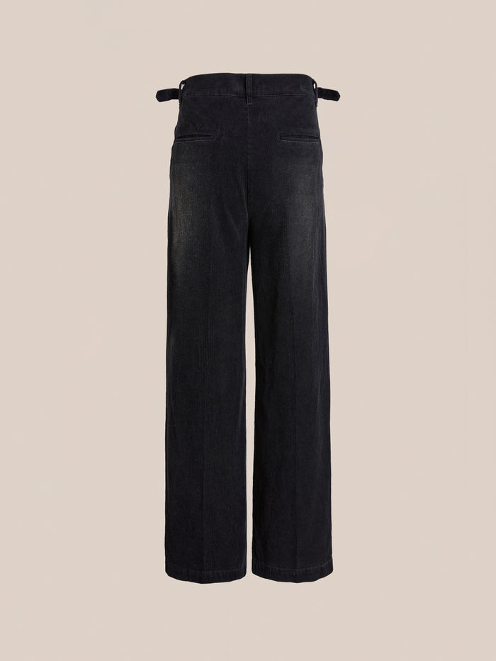 FOUND Faded Pleated Corduroy Pants feature a high waist, wide legs, double pleats, two back pockets, and adjustable side tabs, shown on a plain beige background.